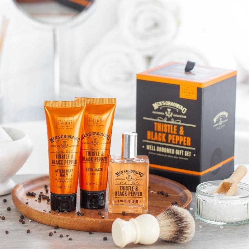 Gifts for him. Image of mens grooming products with gift box, shaving brush and orange bottles